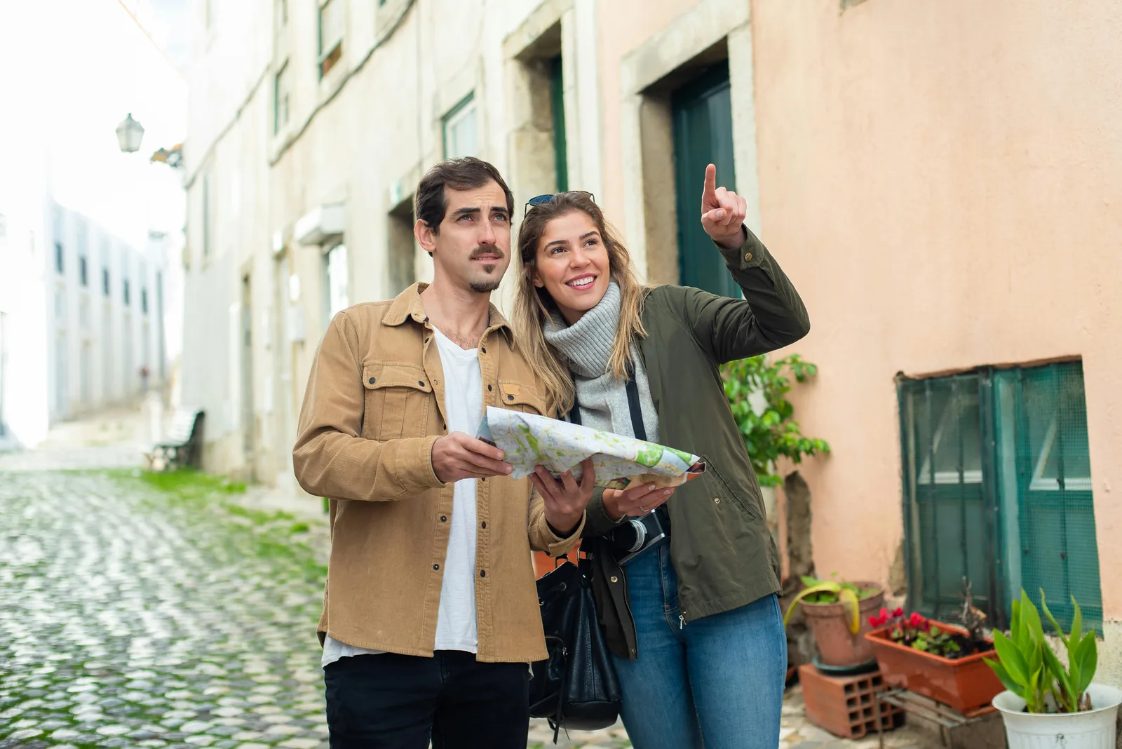 A couple with a map exploring an old Italian town street — choosing the right academic path in Italy with AcademItaly